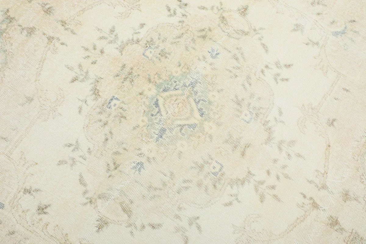 Detailed view of the central medallion and surrounding floral motifs on the rug