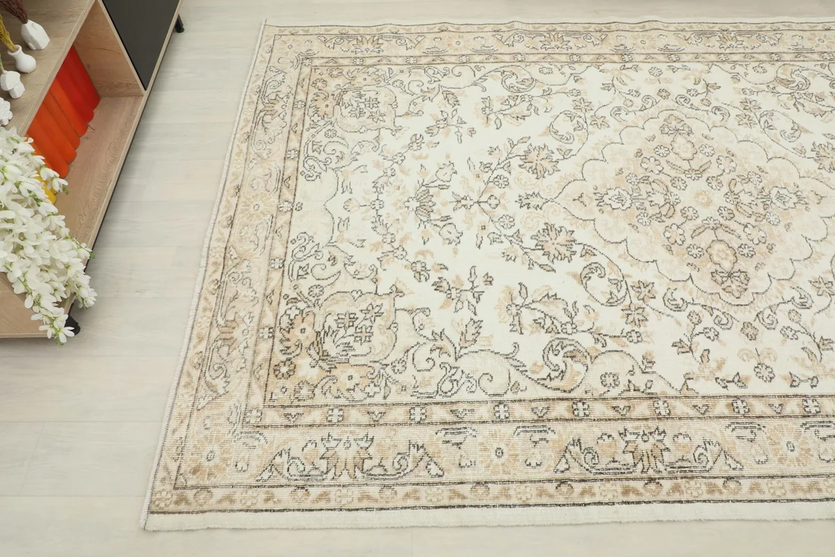 Overhead angle capturing the intricate floral patterns and muted colors of the vintage Anatolian rug.