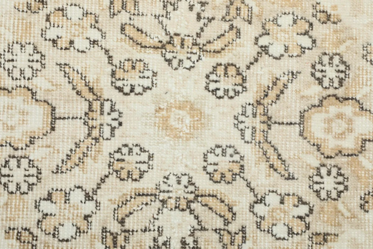 Close-up of the hand-knotted wool pile, showing texture and subtle color variations from wear.