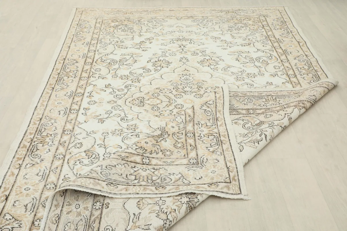 The rug partially folded back, showing its flexibility and the consistent design from front to back.