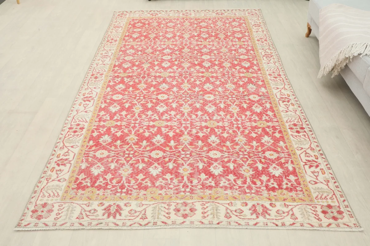 Full overhead view of the red floral vintage rug in a modern room, demonstrating its scale.