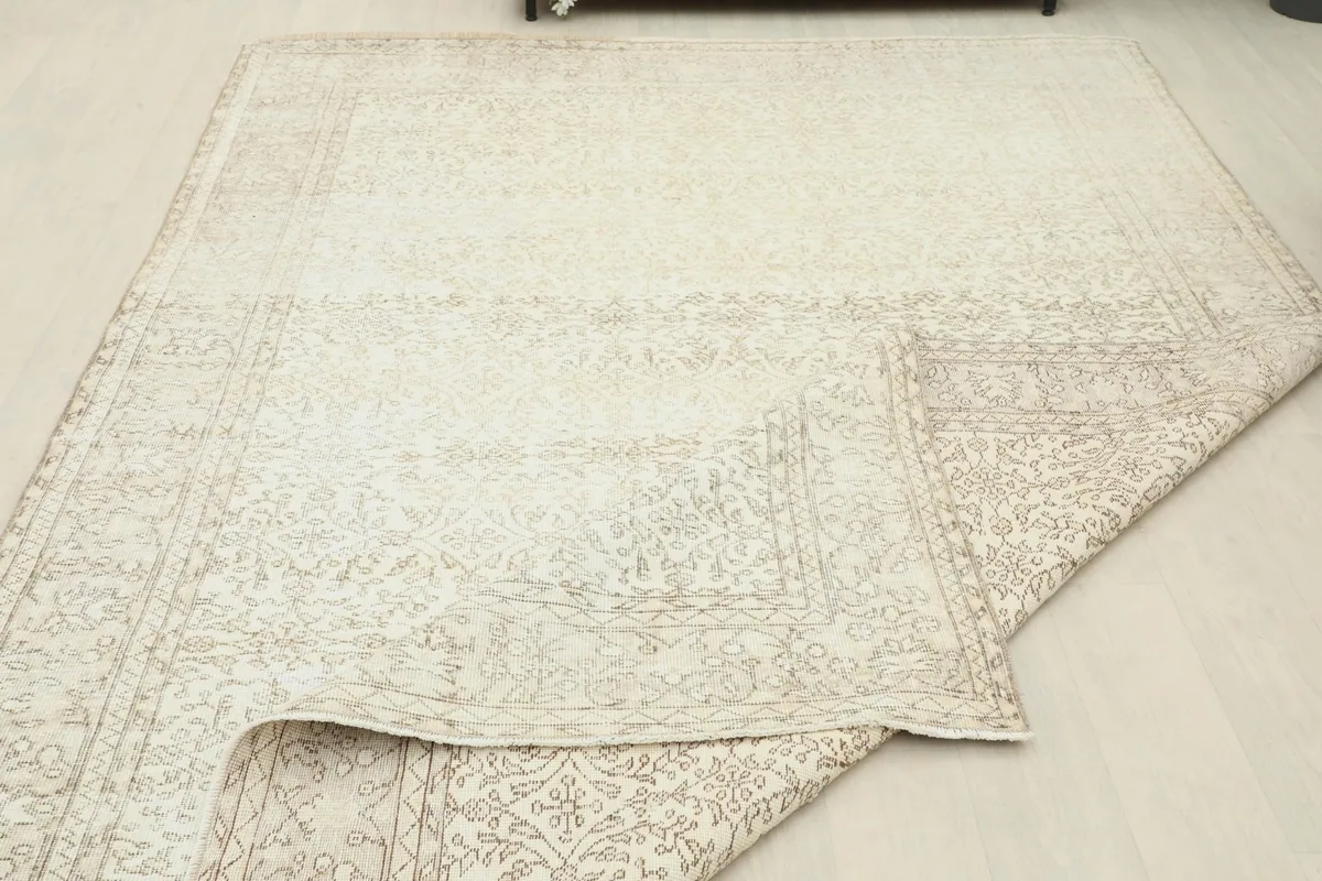 View of the rug partially folded, revealing the consistent hand-knotted construction