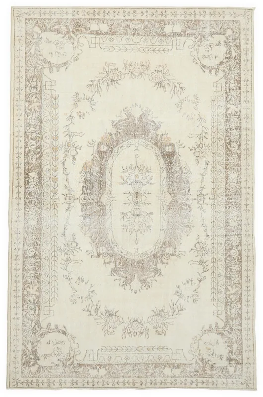 Full top view of the 6'9" x 10'8" ivory and tan vintage Anatolian area rug on a white background.