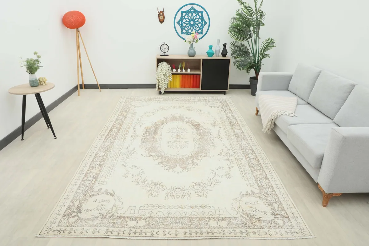 Full room view of the vintage ivory and tan rug, complementing the surrounding furniture.
