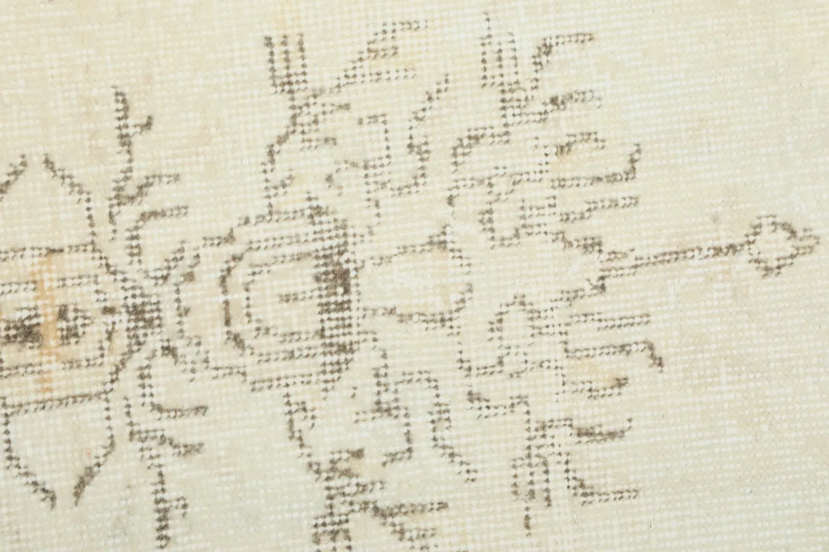 Detailed close-up of the subtle geometric patterns within the rug's design.