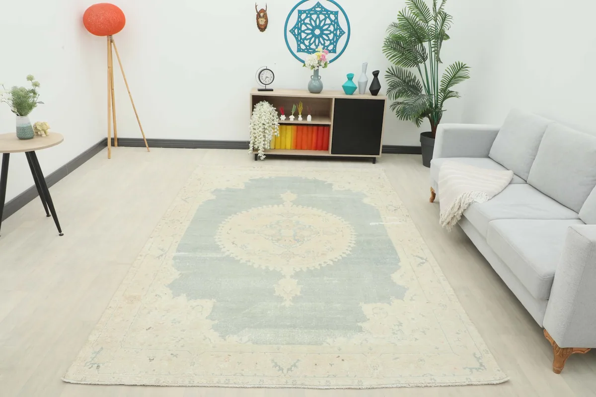 Wide shot of the vintage rug in a room, providing a full perspective of its size and design in context.