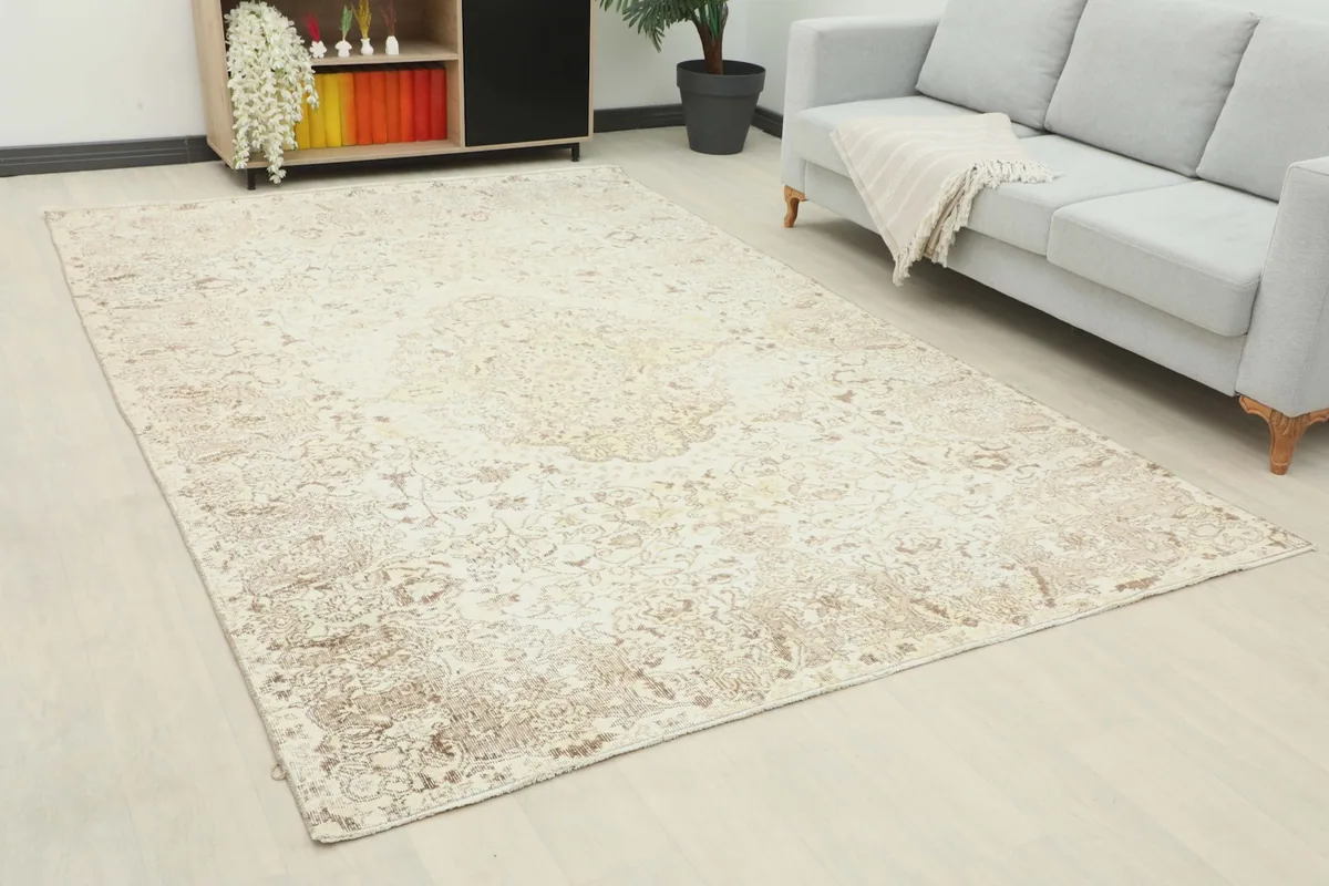 Wide angle view of the ivory and beige vintage rug complementing a modern living space.
