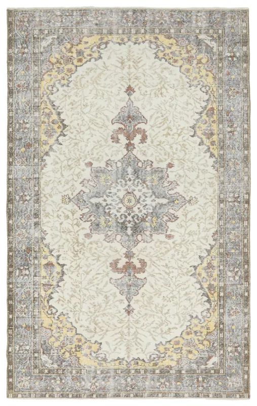 Full top view of the 5'8" x 9'1" vintage Anatolian rug with a cream field and gray border.