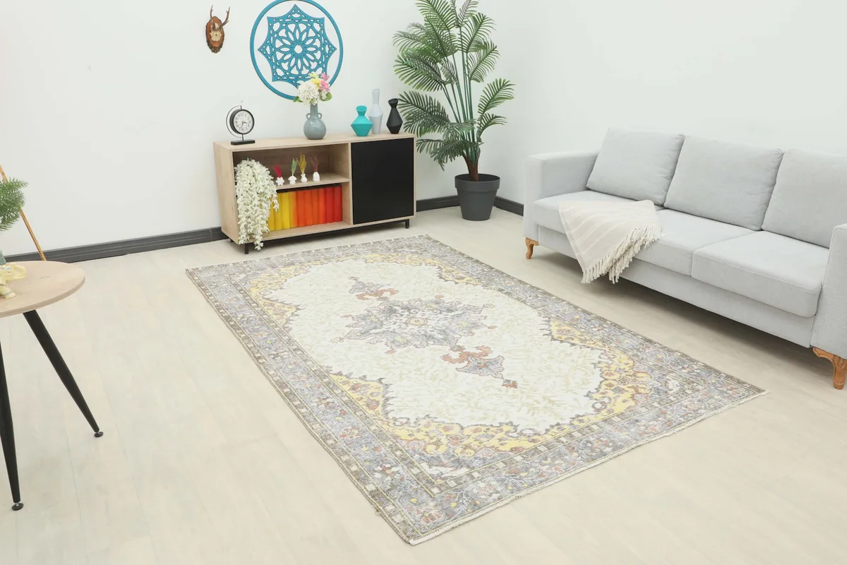 Area rug laid out in a modern living space with a light sofa and side table.