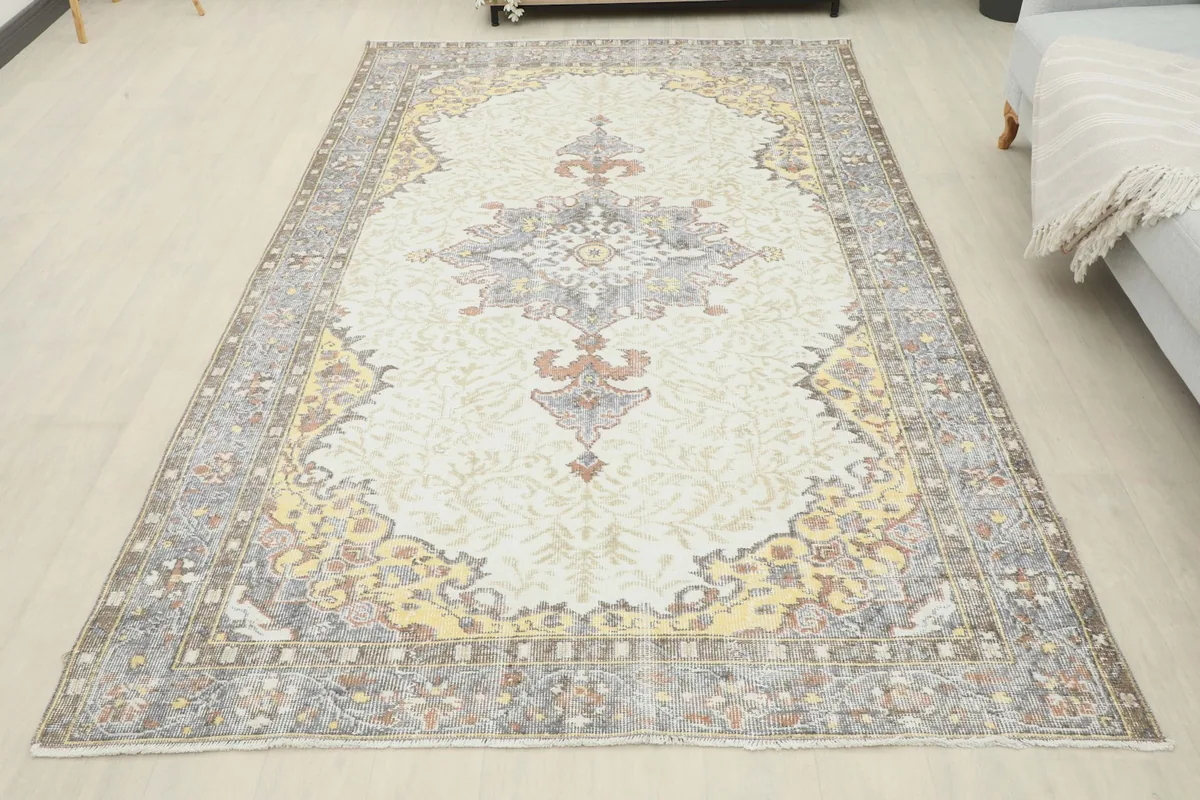 Full overhead view of the vintage Anatolian rug, showcasing its complete design and colors in a room setting.