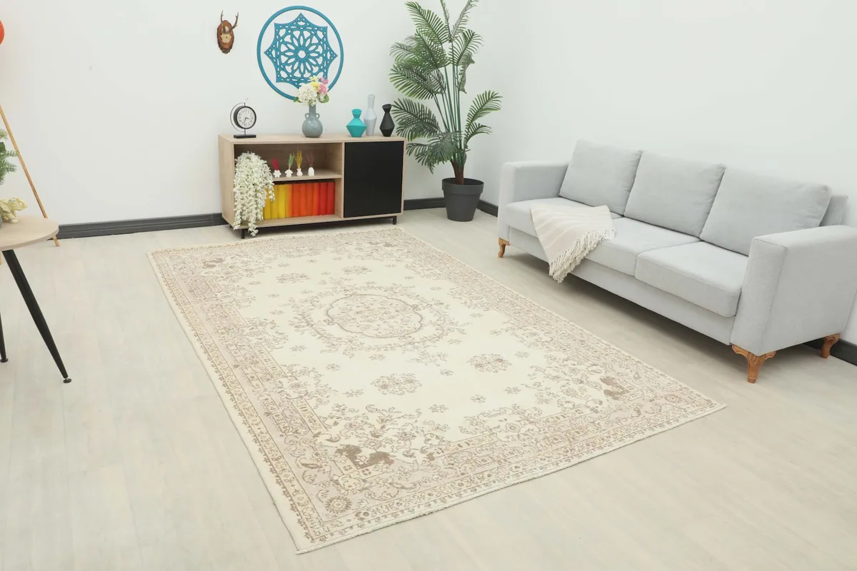 Vintage Anatolian rug displayed in a bright living room setting with a light gray sofa.