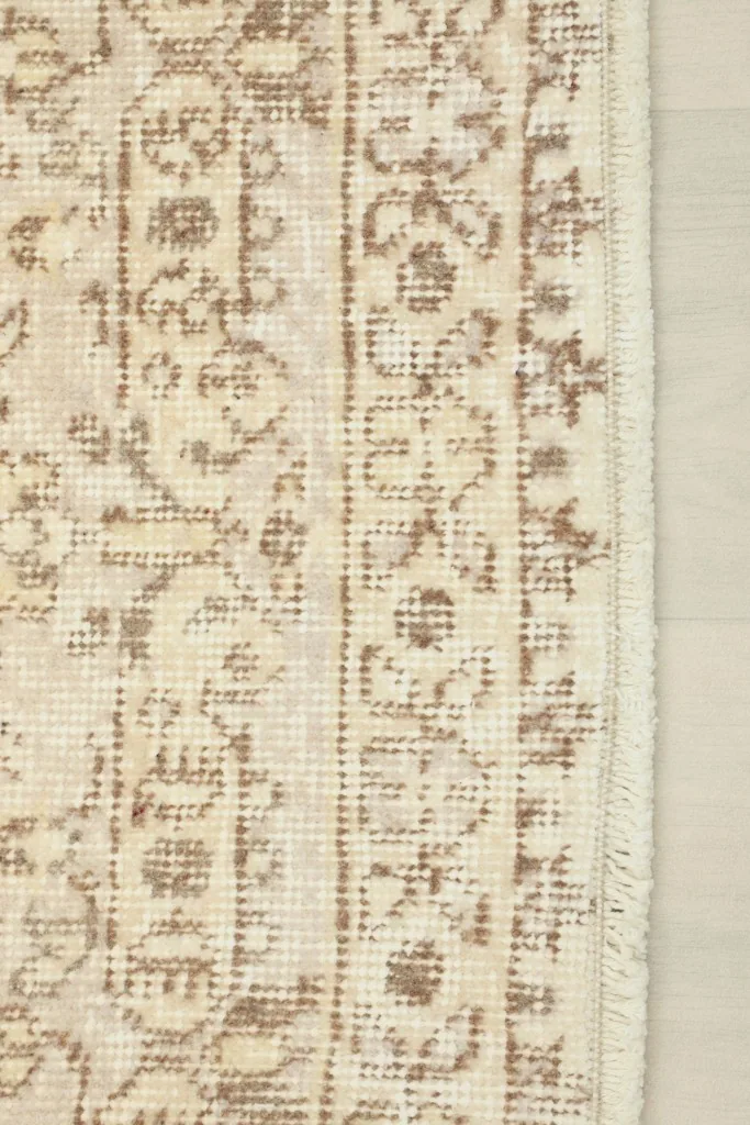 Detailed edge of the rug, showing the hand-knotted border and short fringe.