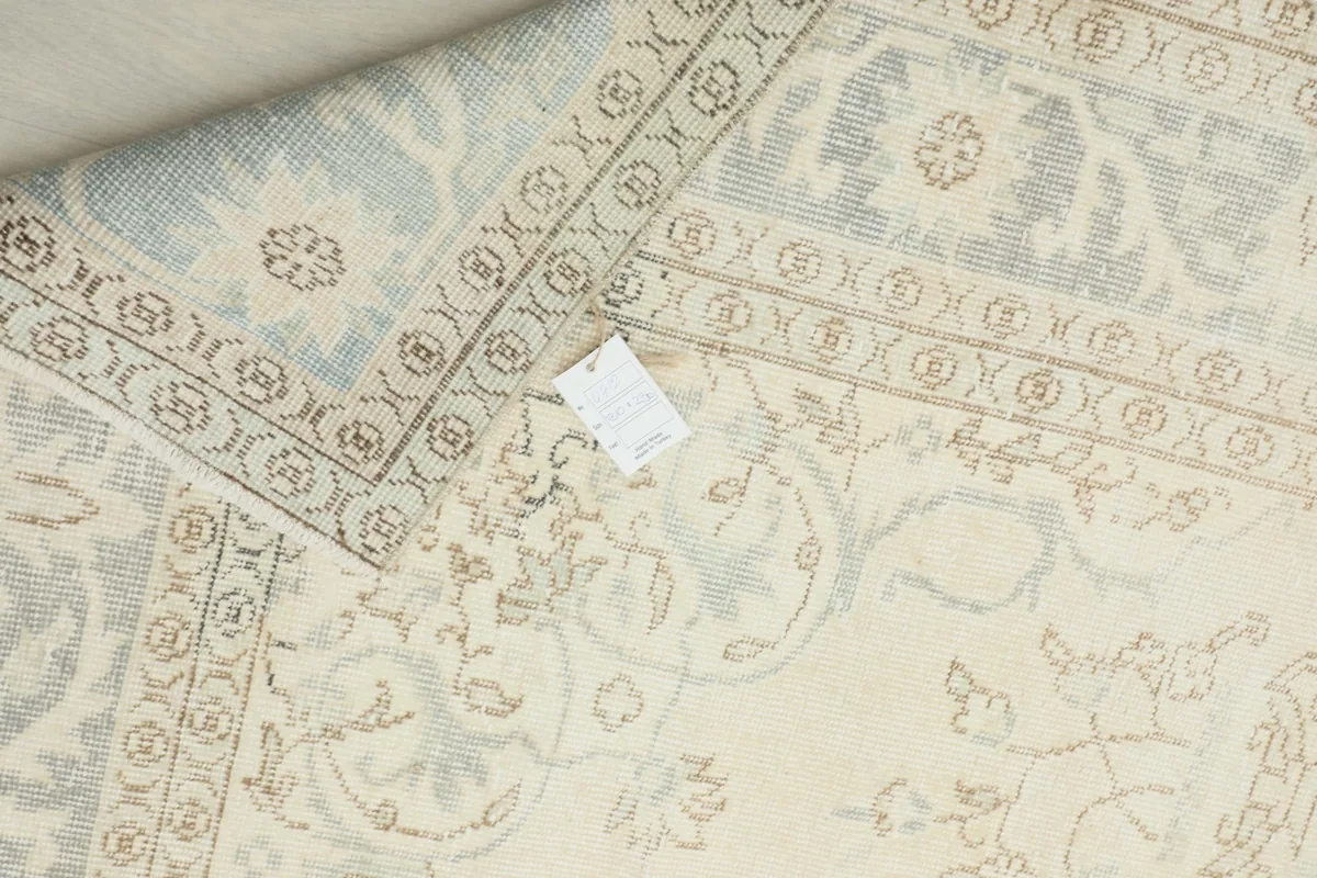 Close-up of the rug's back, displaying the tight knotting and foundation structure