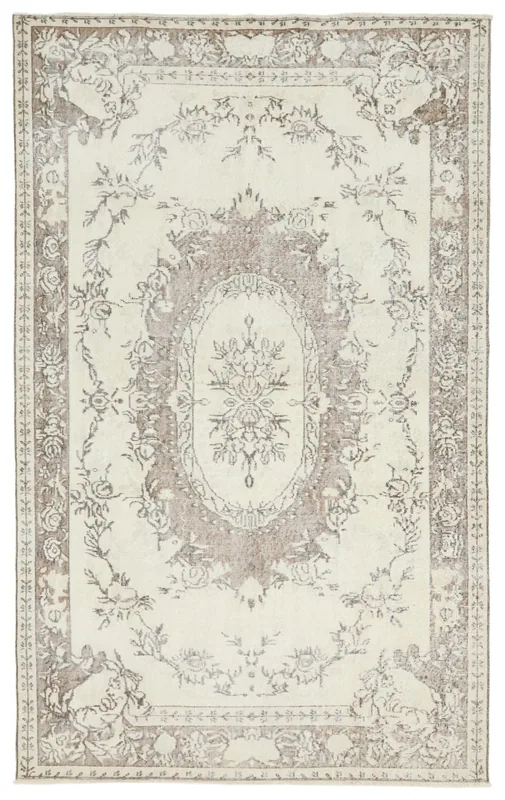 Full overhead view of the 5'3" x 8'5" vintage Anatolian rug with ivory field and brown floral medallion.