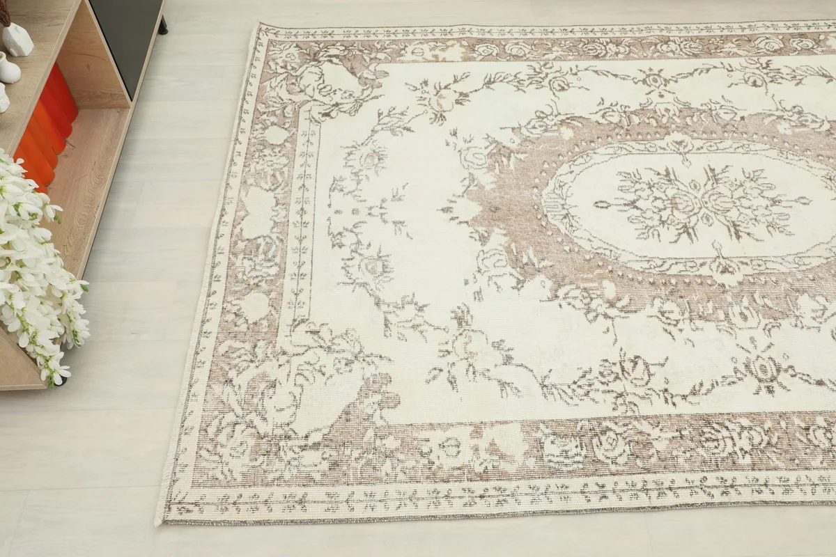Angled view of the rug's pattern and colors, highlighting the distressed finish.