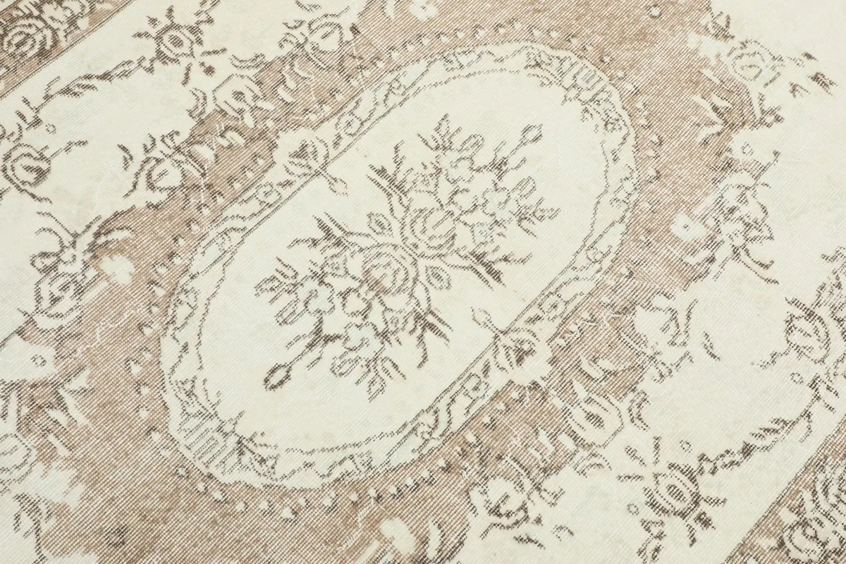 Detailed close-up of the central floral medallion and surrounding motifs.