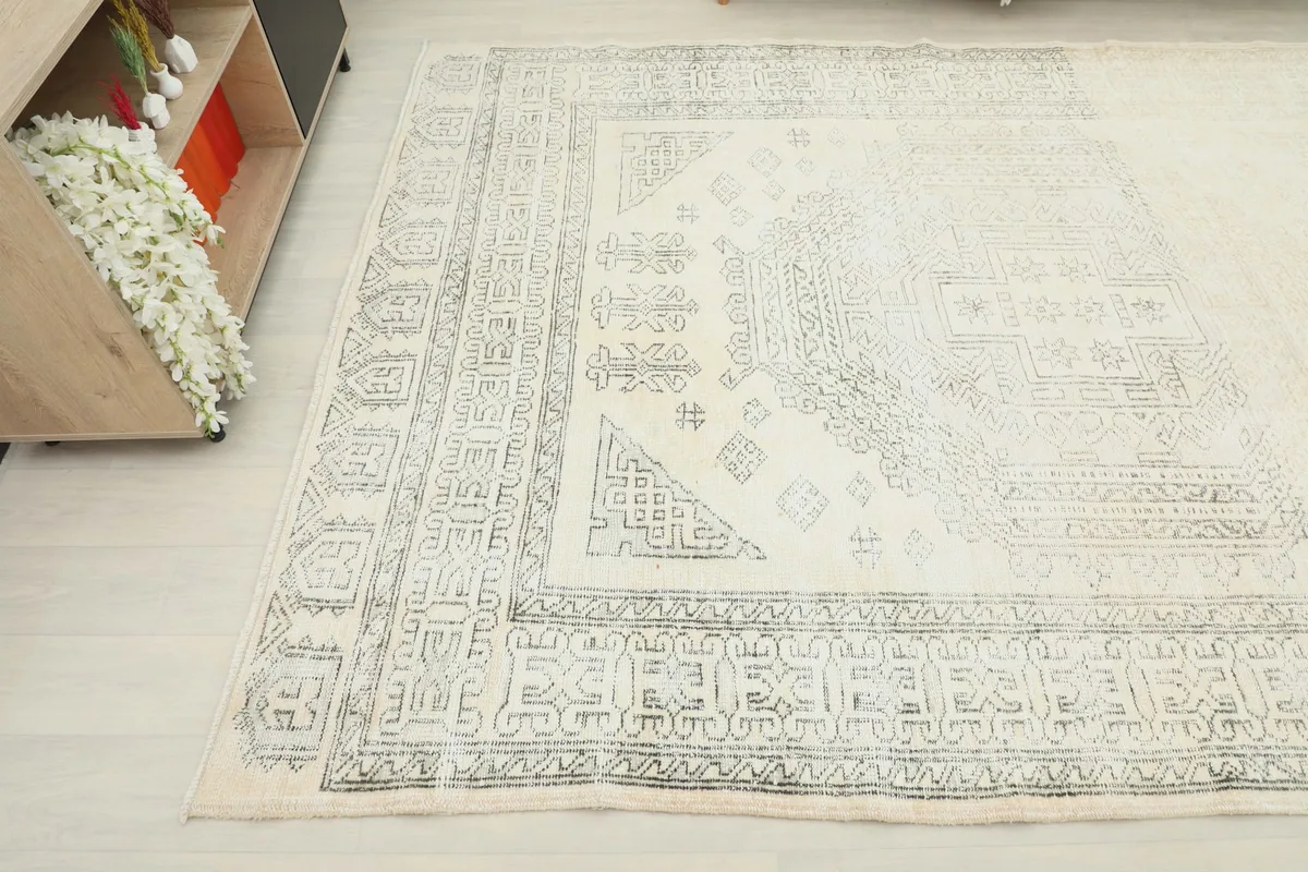 Close-up angle of the vintage rug's border and central design