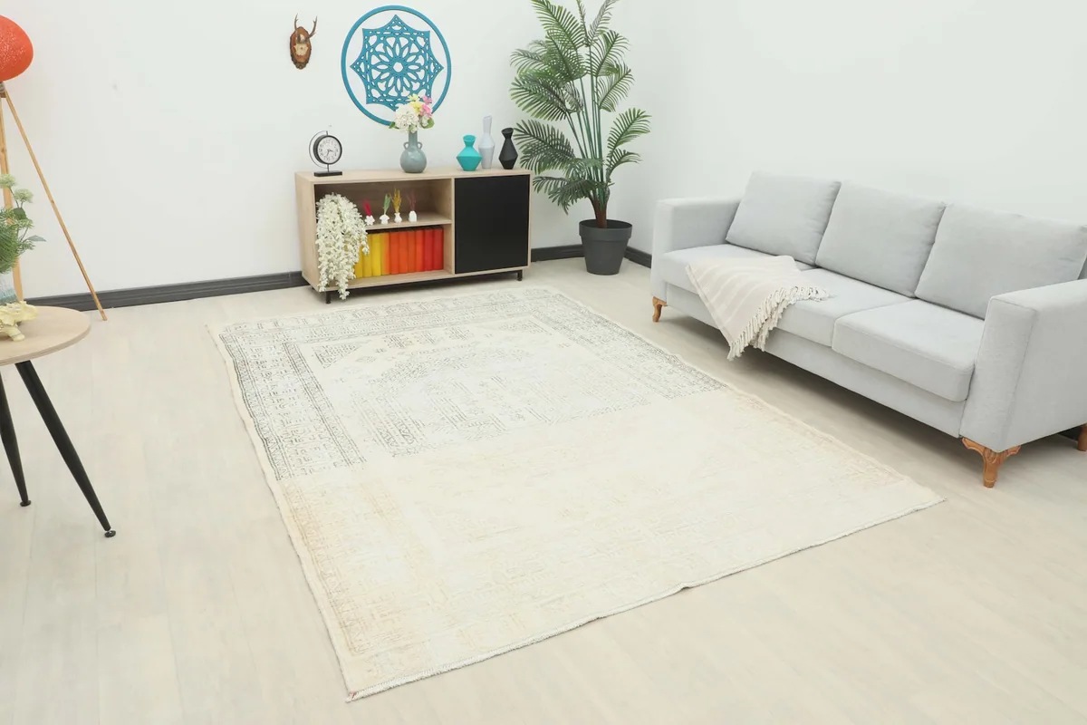 Vintage Anatolian rug in an open living room with a gray sofa