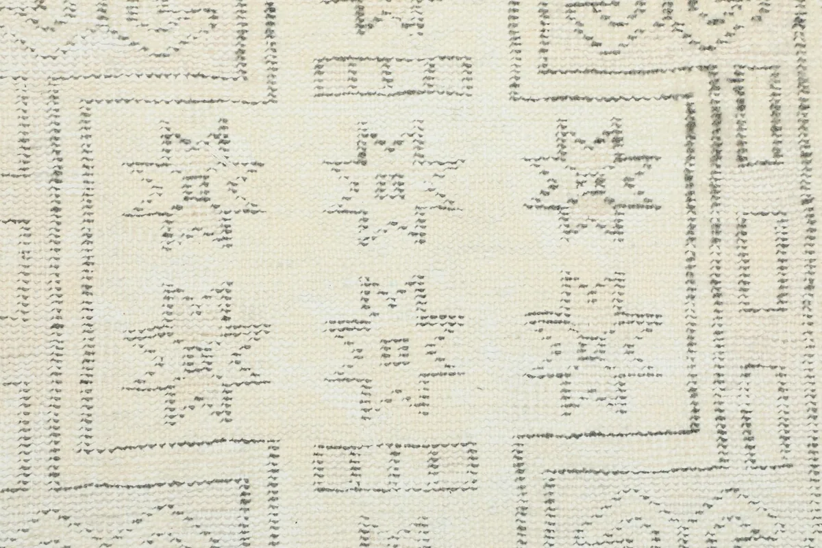 Close-up of the intricate star-like geometric patterns in gray