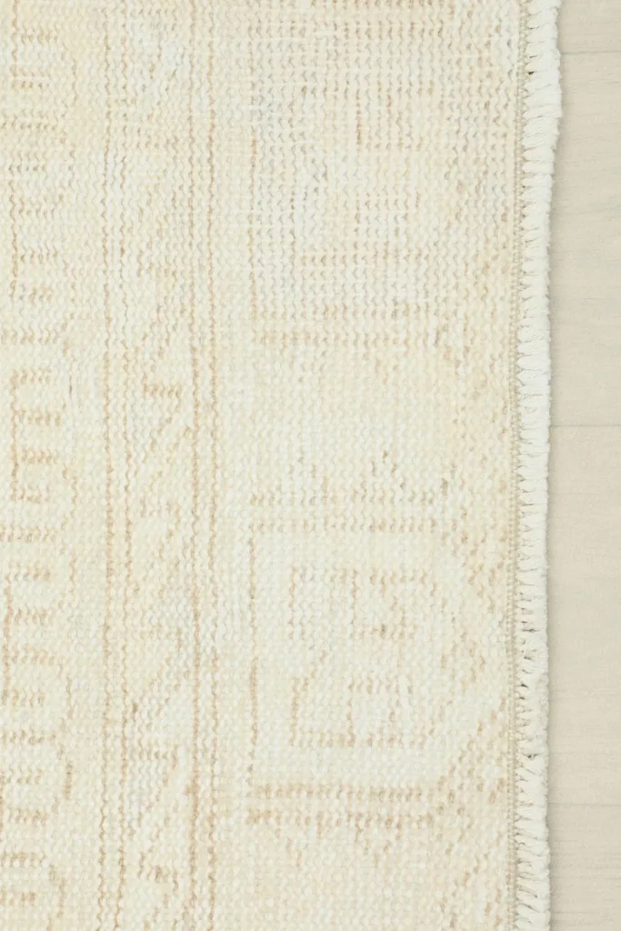 Close-up of the hand-knotted fringe and side edge of the rug