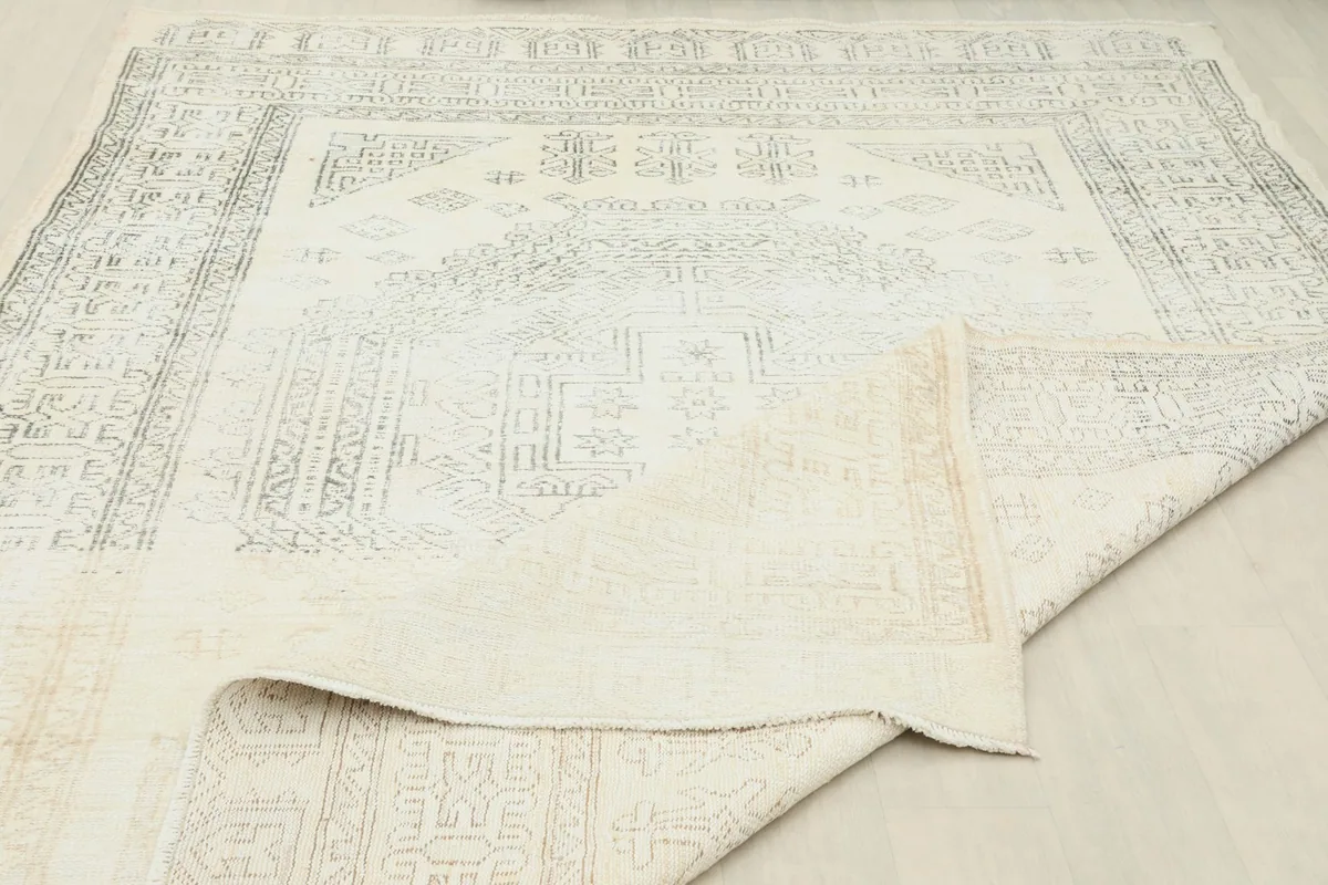 Rug partially folded to reveal the backside and knotting detail