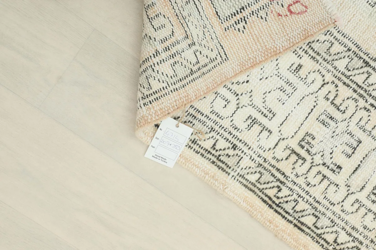 Rug label visible on the back of the vintage hand-knotted rug
