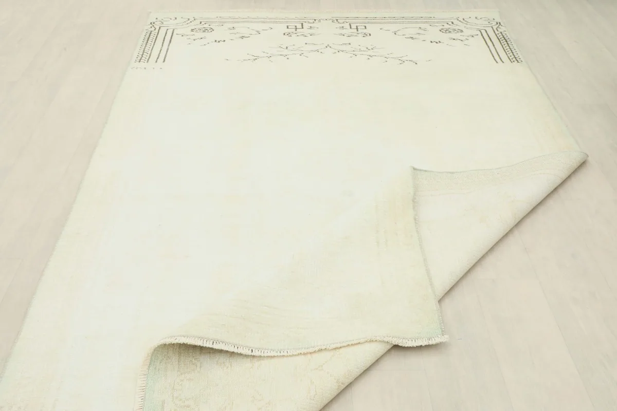 Rug partially folded to show the flexibility and construction of the vintage Anatolian piece.