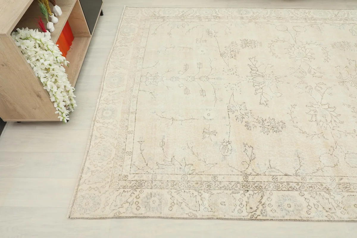 Overhead angle view of the rug, highlighting the soft ivory field and subtle patterns.