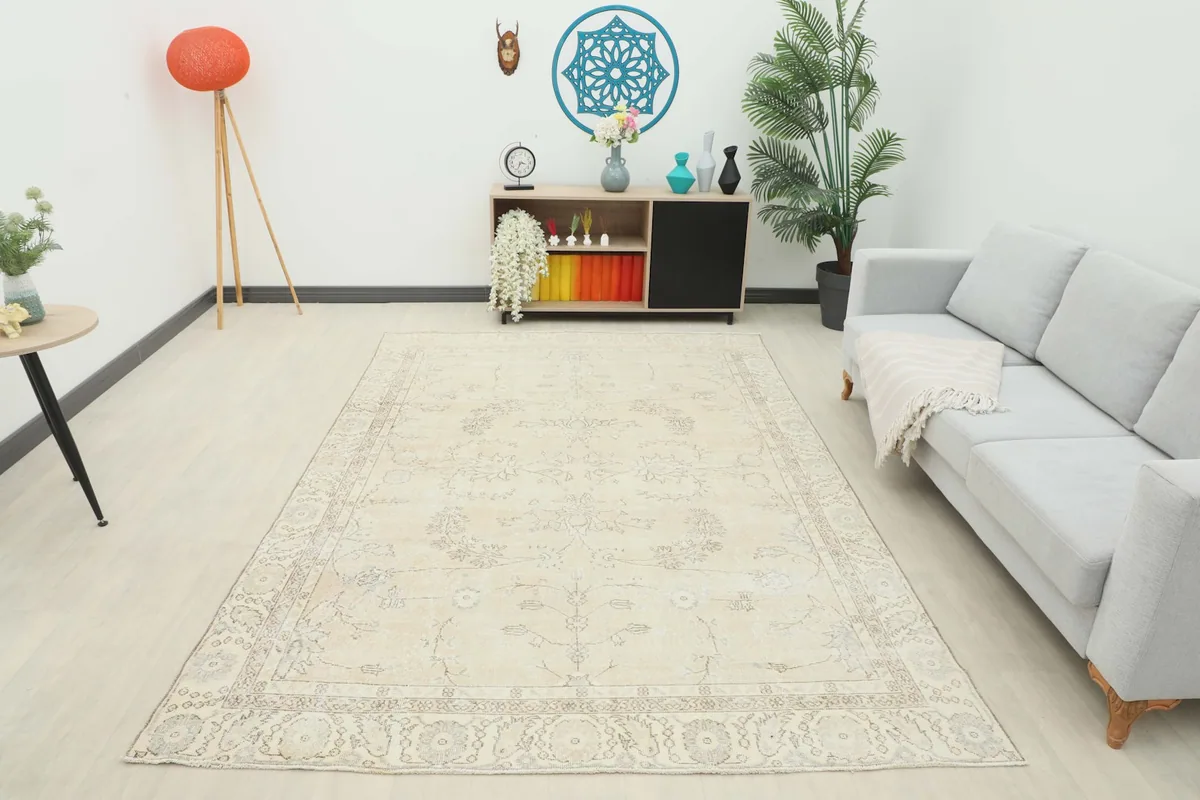 Full room view of the ivory vintage rug, demonstrating its presence and scale in a living space.
