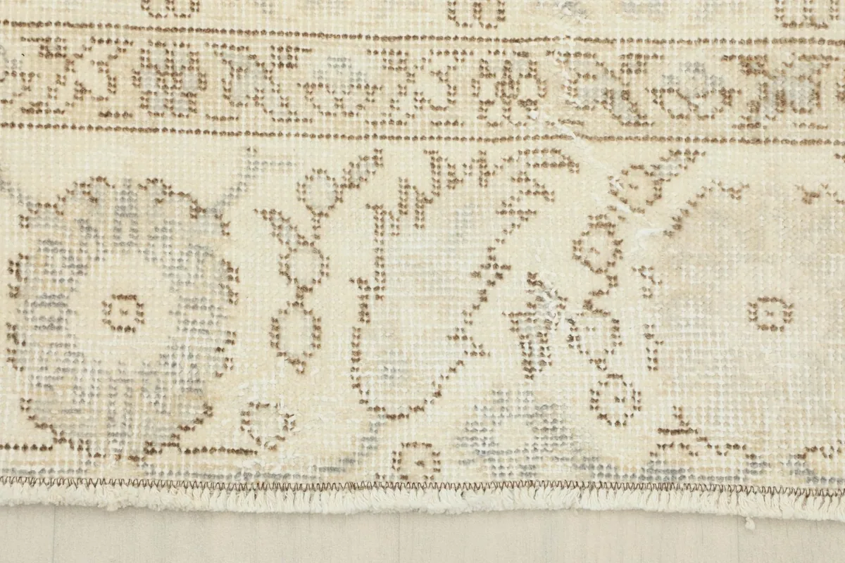 Close-up of the rug's border, showcasing the traditional motifs and the short fringe.