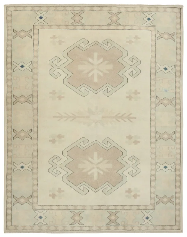 Full overhead view of the ivory and tan geometric tribal area rug on a white background