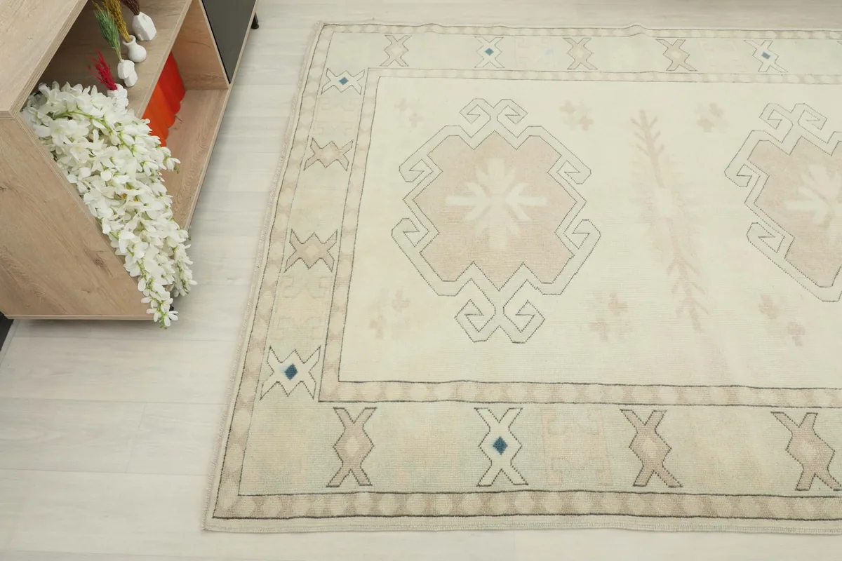 Overhead angle shot of the rug's center and border design, showing the subtle blue accents