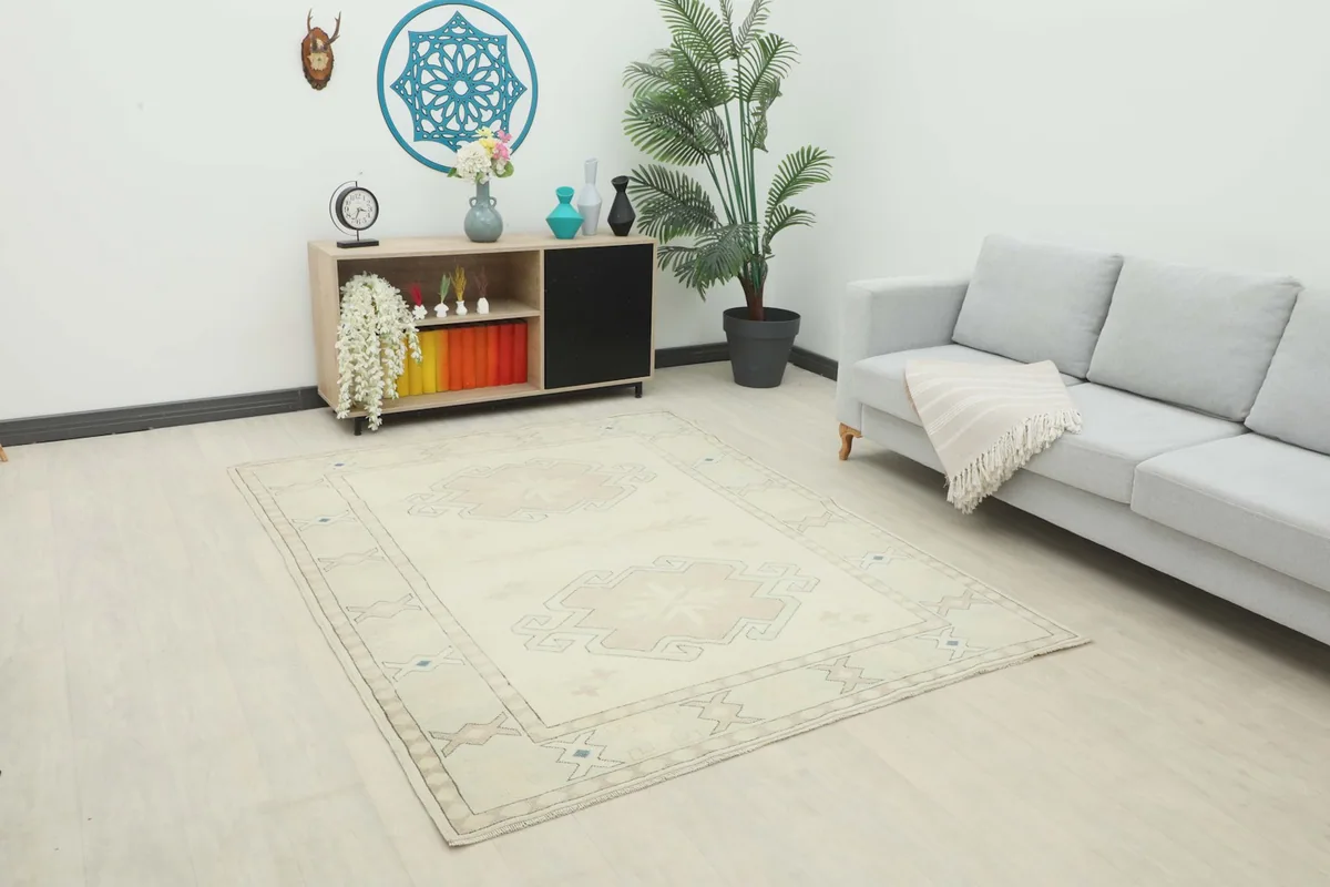 Ivory and tan rug displayed in a modern living room setting with a light gray sofa