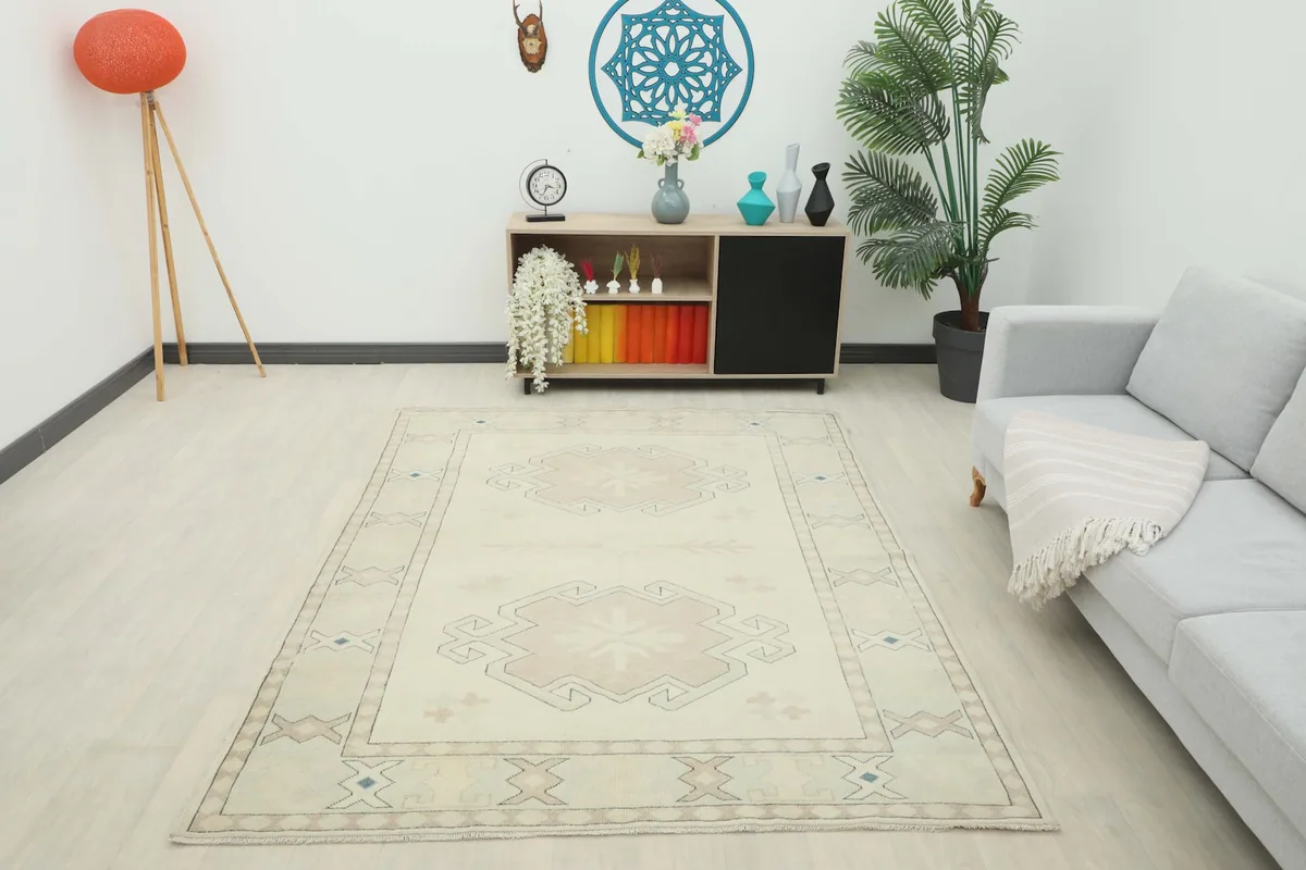 Full room view of the large ivory and tan rug, demonstrating its scale and presence in a living area