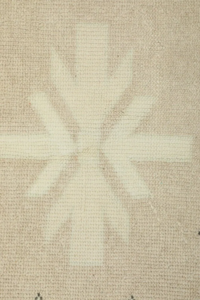 Close-up of the woven texture and a faded inner motif, showing the low pile