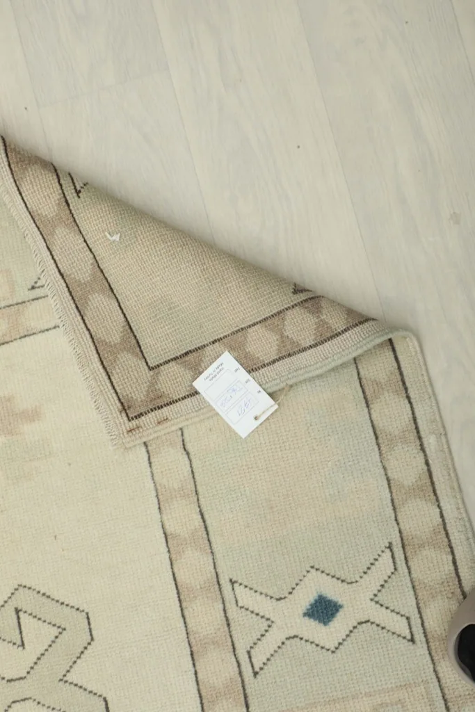 Close-up of the rug's underside, showcasing the hand-knotted wool pile on cotton foundation
