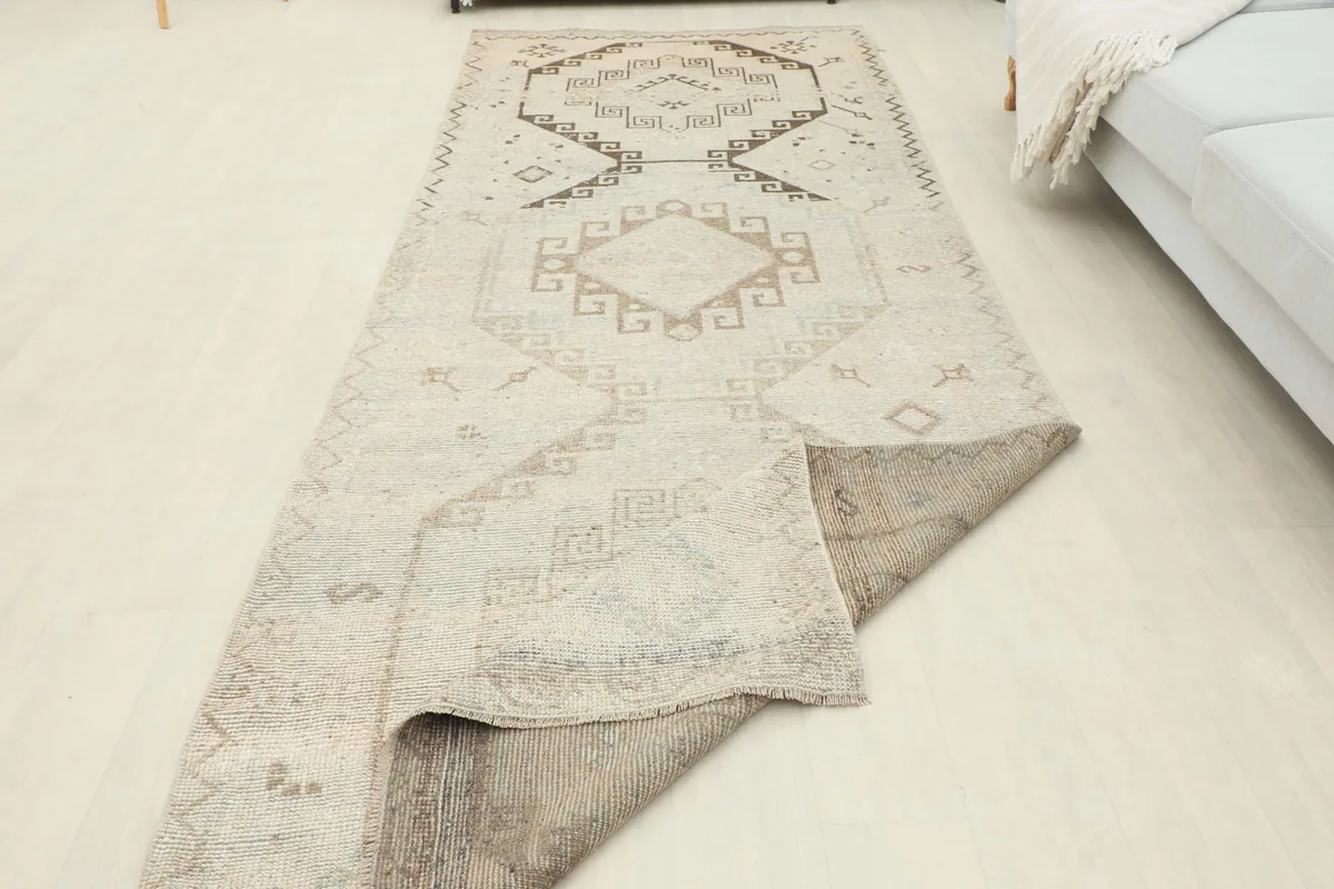 The runner partially folded, showing the underside and the overall length in a room setting.