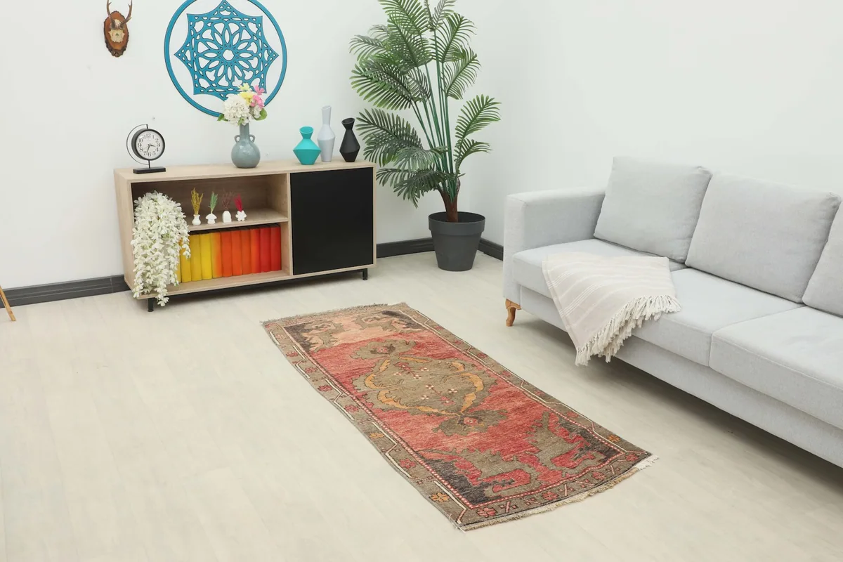 Vintage rust runner rug displayed in a modern living room setting with a light gray couch