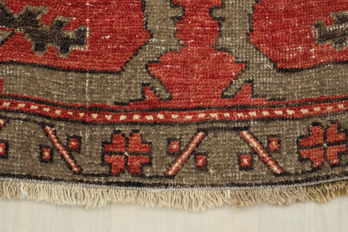 Close-up of the rug's border design and one end with short fringes