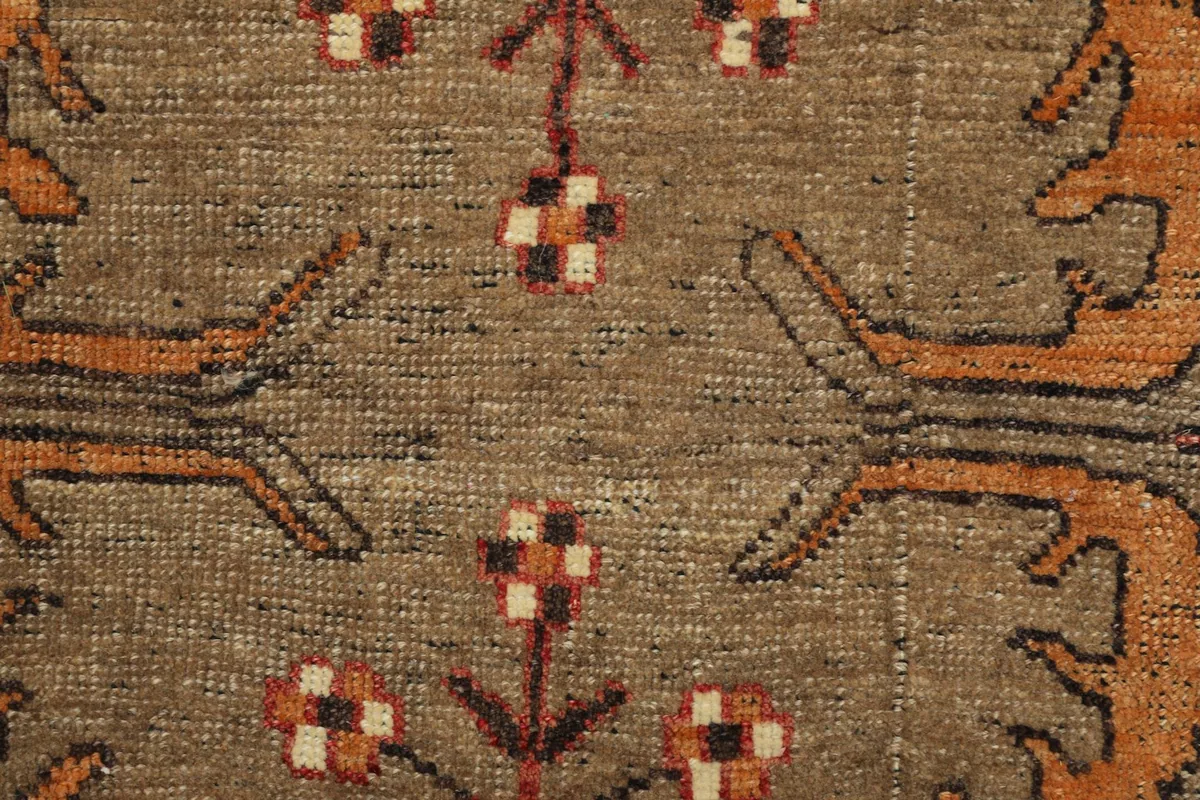 Extreme close-up of the low wool pile and hand-knotted texture of the rug