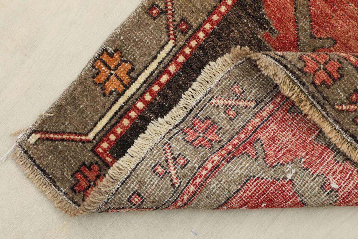 Close-up of the folded corner, revealing the cotton foundation and reverse side of the rug