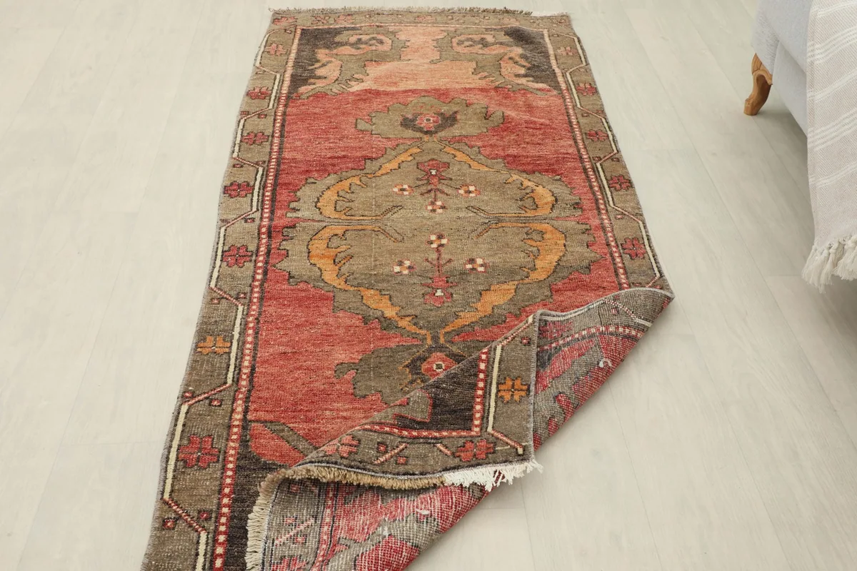 View of the runner rug with a corner folded to show its thickness and underside