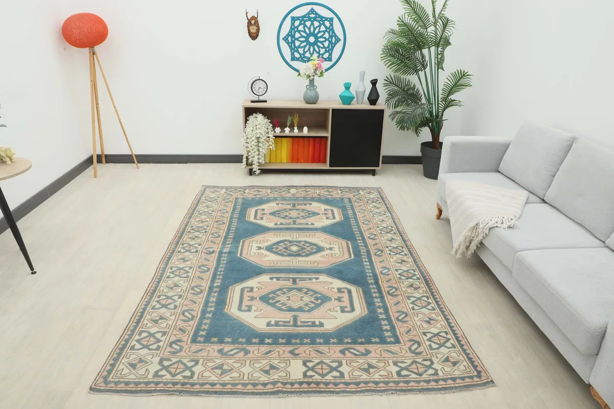 Full room view of the blue geometric vintage rug anchoring the living space
