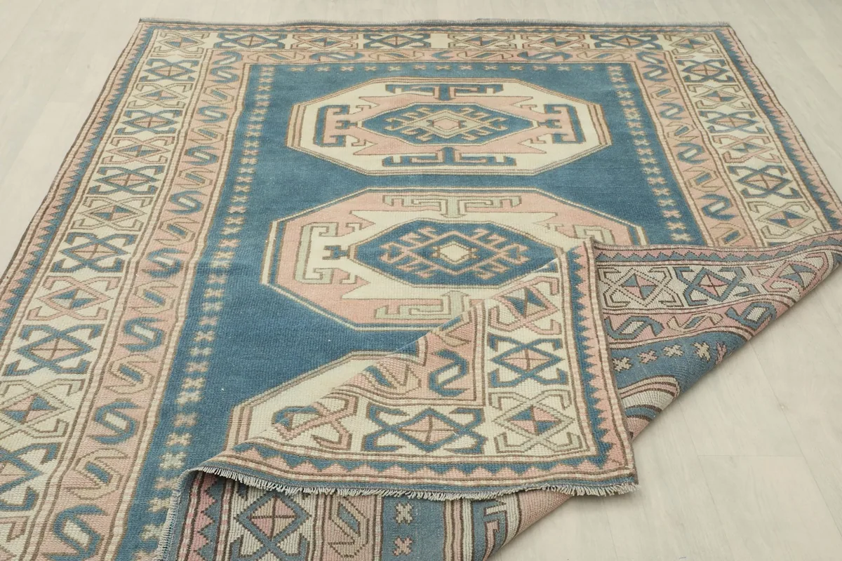 Rug partially folded, illustrating its thickness and construction