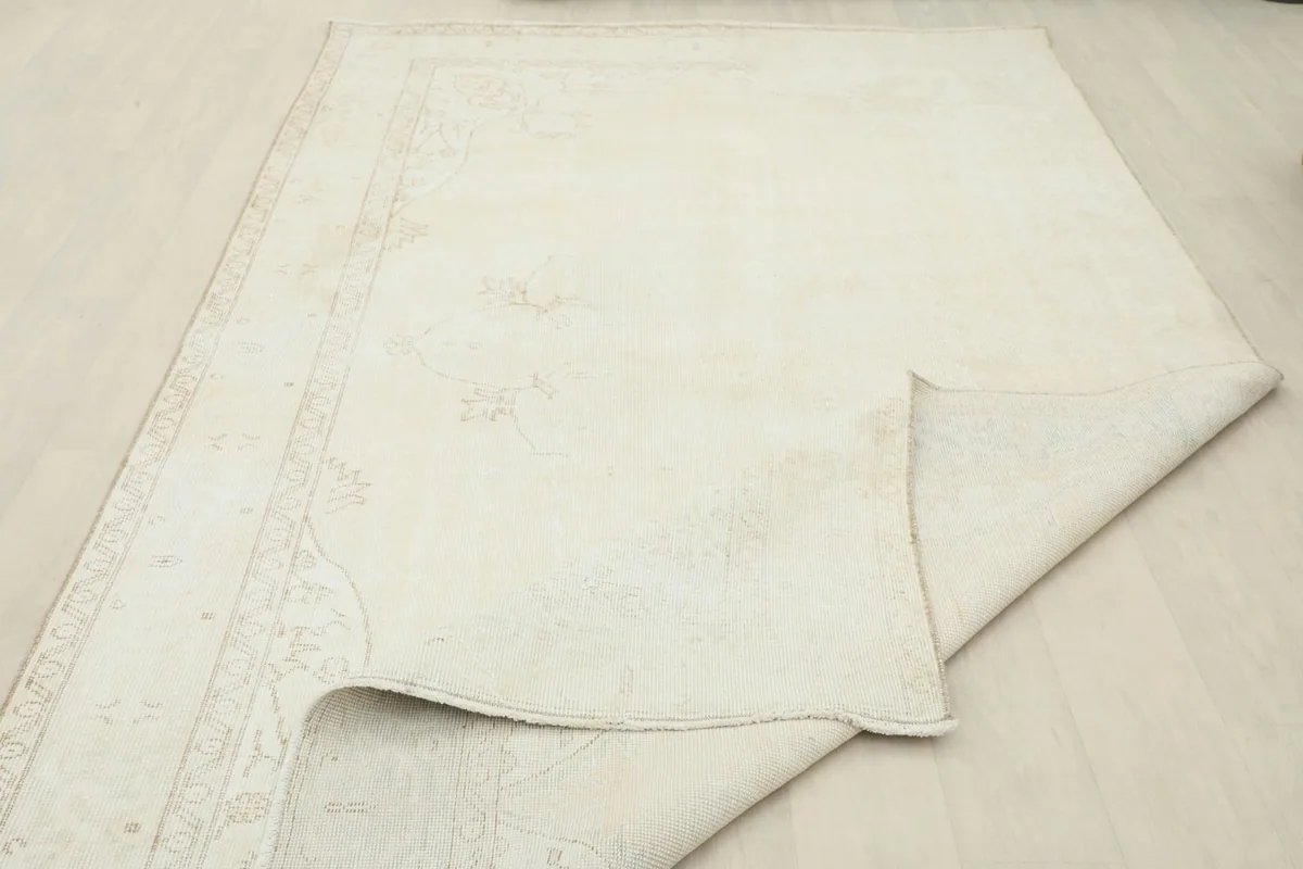 Another folded view showing the rug's flexibility and the detailed border design.