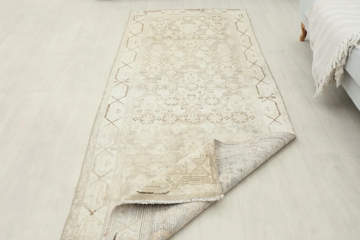 Rug corner folded back to show the thickness and construction of the vintage runner.