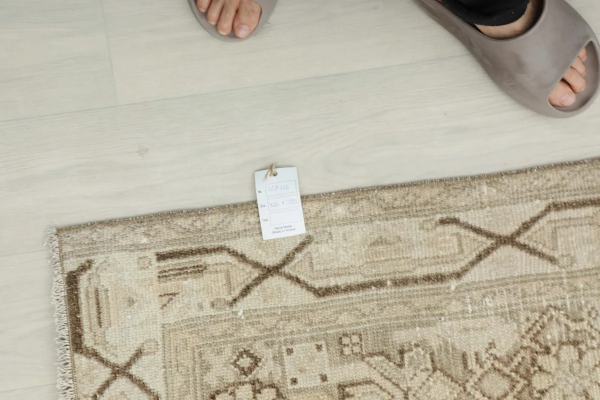 Overhead view with a size tag next to the rug, showing scale and detail of the pattern.