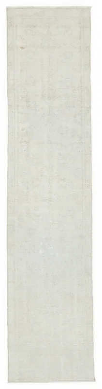 Full top view of the 2'5" x 10'6" ivory vintage Anatolian runner on a white background.