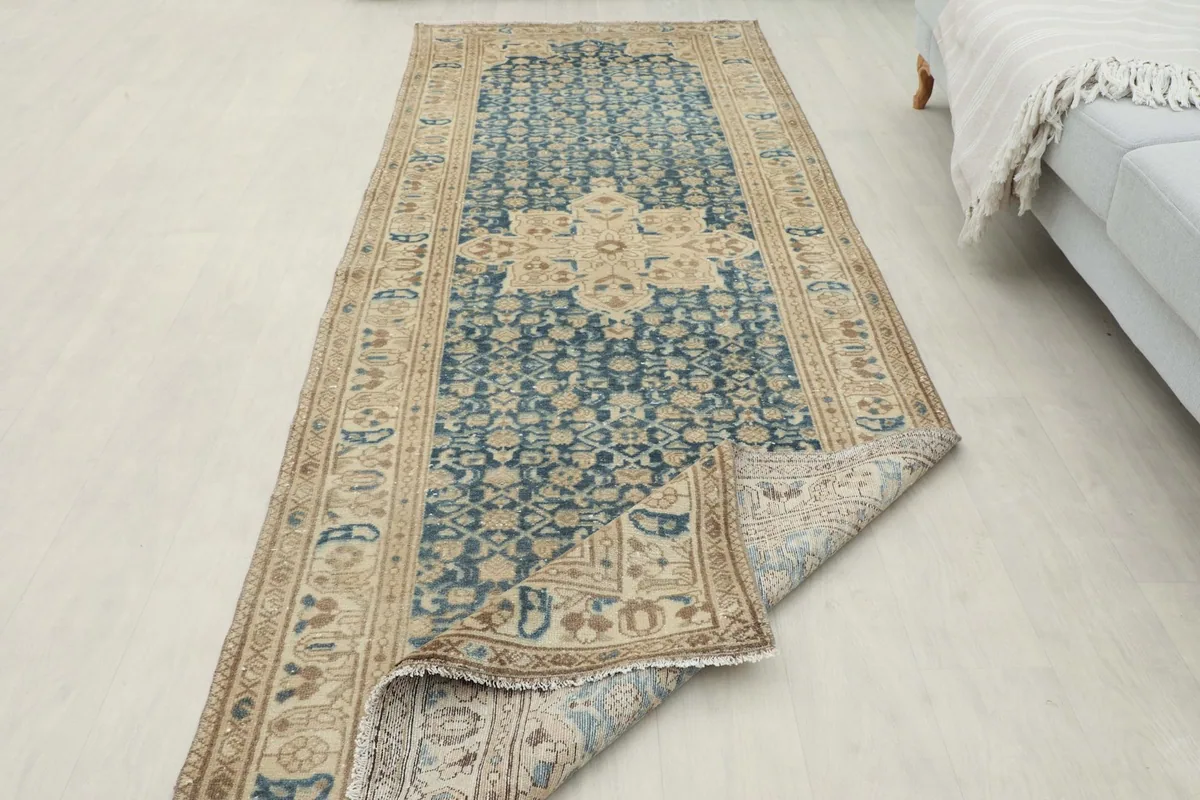 Rug partially folded to show its flexibility and thickness