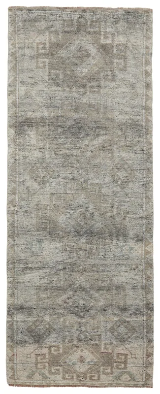 Full overhead view of the 4'1" x 10'5" gray and beige Anatolian runner with geometric patterns
